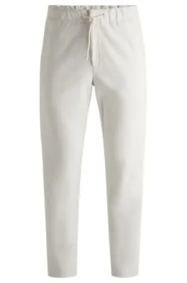 Pantalones tapered fit de pana técnica